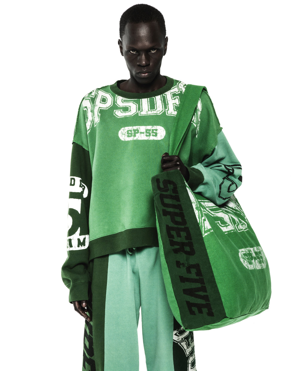 Green 8oz brushed twill SUPERFIVE TOTE with SP5DER graphic, worn by a model.