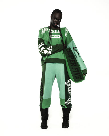 Green 8oz brushed twill SUPERFIVE TOTE with SP5DER graphic, held by a model.