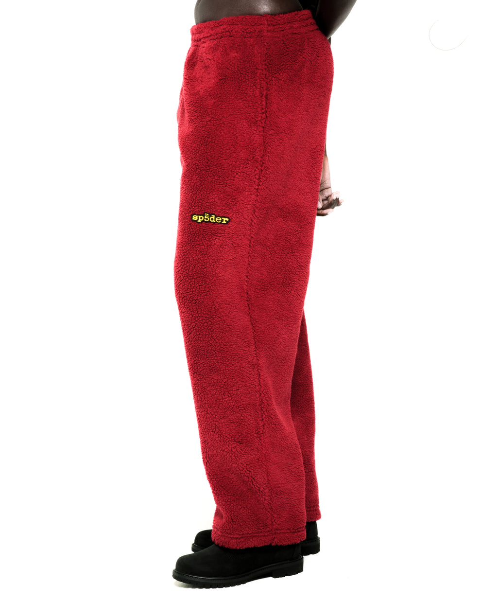Red sherpa fleece pant with yellow "sp5der" logo, elasticized drawstring waistband, and straight leg fit.