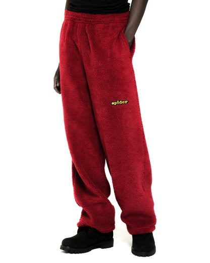 Red sherpa fleece pant with yellow "sp5der" logo, elasticized drawstring waistband, and straight leg fit.