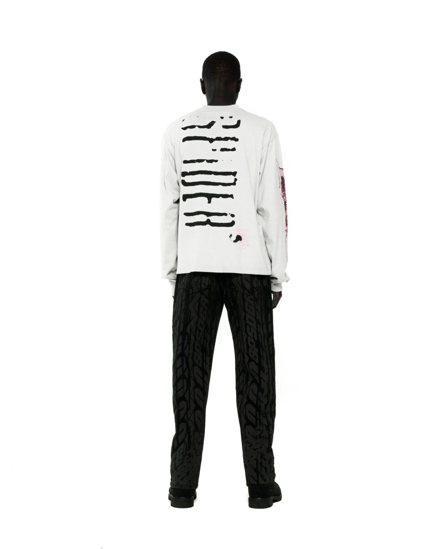 White 100% cotton long sleeve tee with black graphic print on back and sleeves.