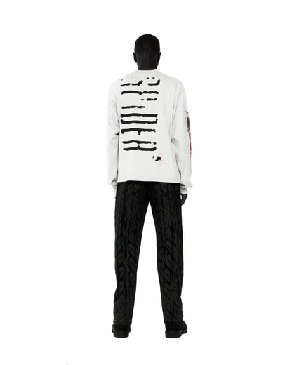 White 100% cotton long sleeve tee with black graphic print on back and sleeves.