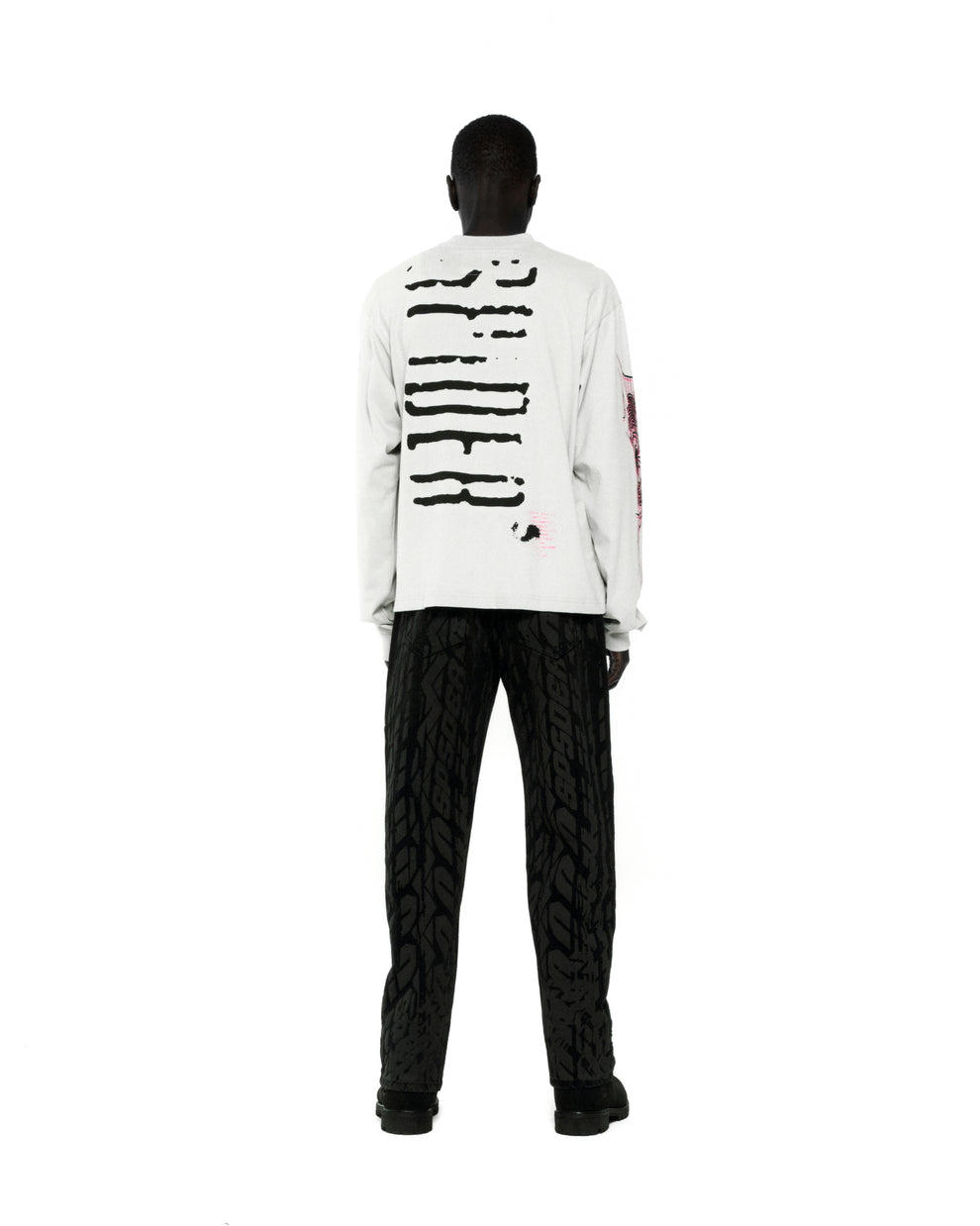 White 100% cotton long sleeve tee with black graphic print on back and sleeves.