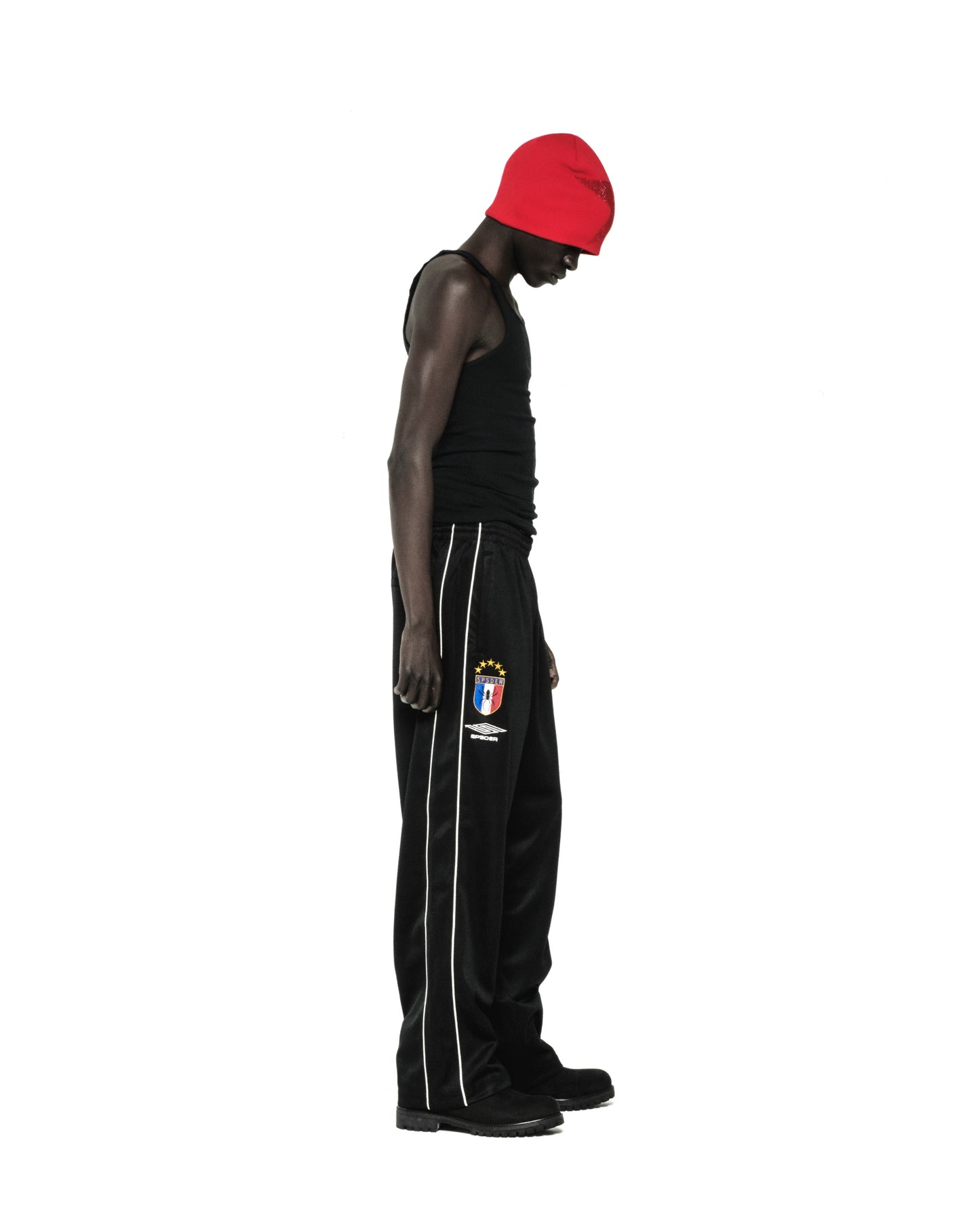 Black Atlanta Track Pant with white side piping, SP5DER crest logo, and wide-leg silhouette.