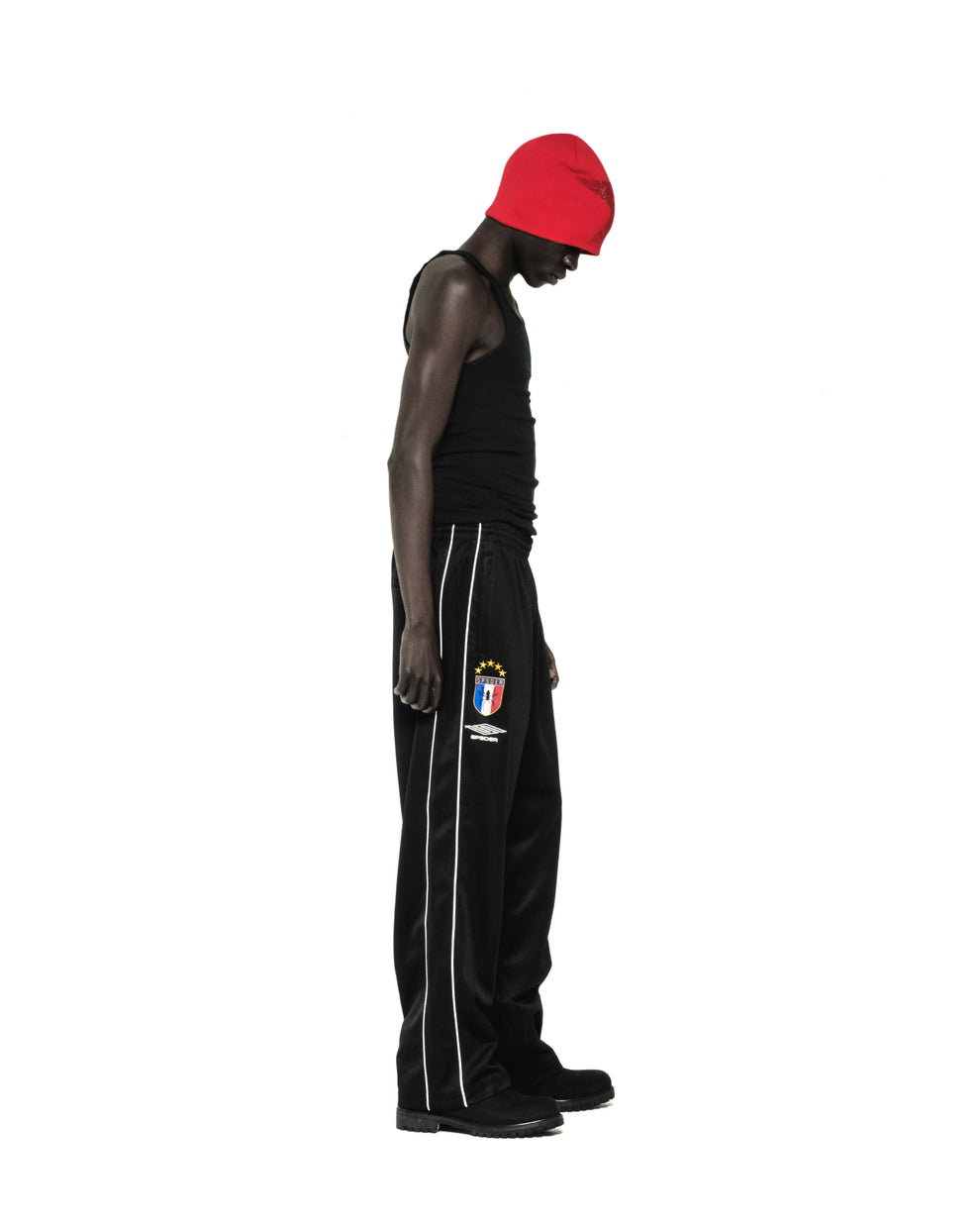 Black Atlanta Track Pant with white side piping, SP5DER crest logo, and wide-leg silhouette.