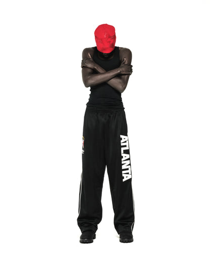 Black ATLANTA TRACK PANT with bold vertical graphic, SP5DER crest, and white contrast piping.