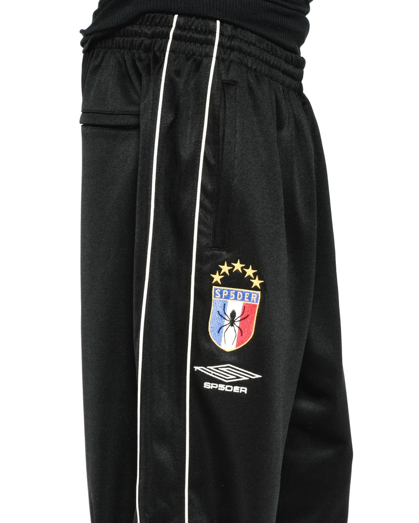 Black ATLANTA TRACK PANT with white side piping, SP5DER crest logo, and elastic waistband.
