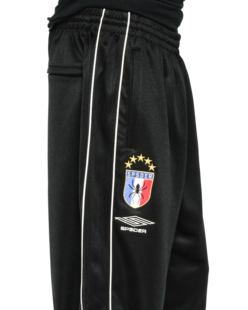 Black ATLANTA TRACK PANT with white side piping, SP5DER crest logo, and elastic waistband.