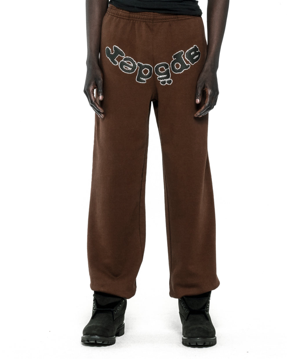 Brown cotton fleece sweatpants with "SP5DER" text in rhinestones across the crotch.