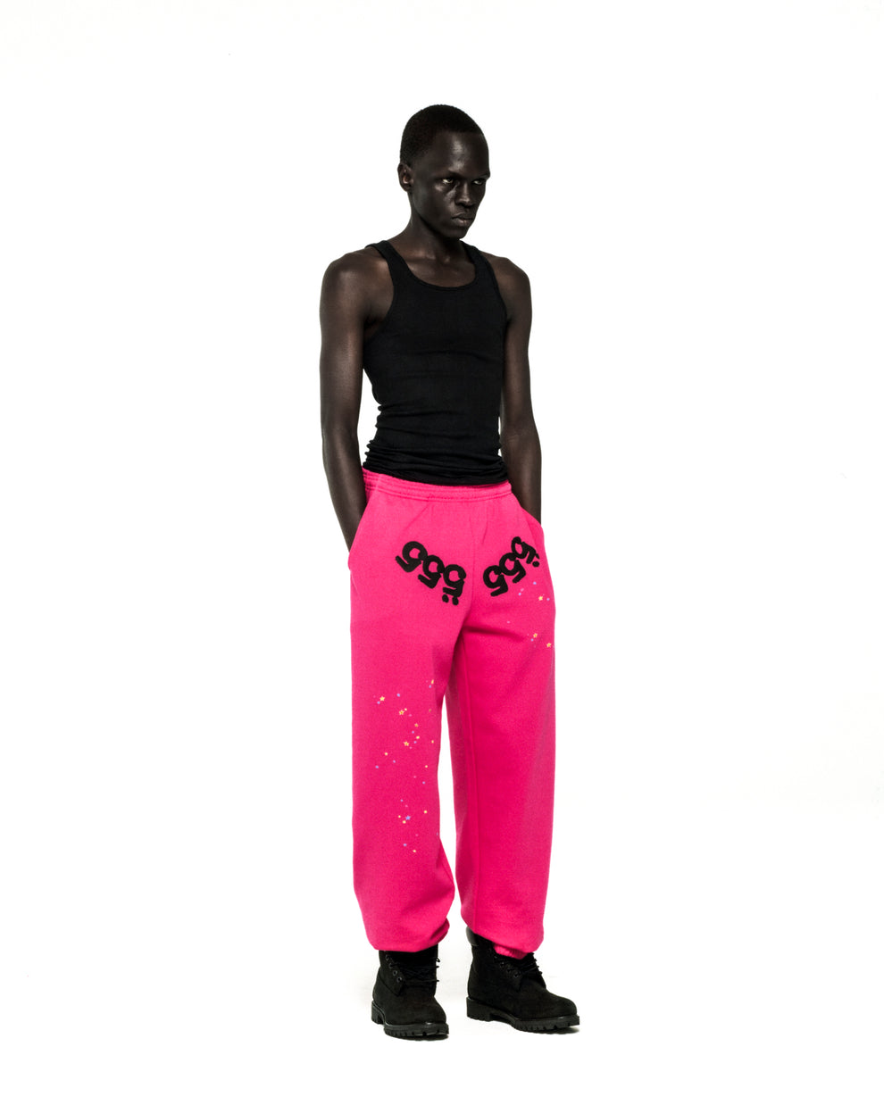 Hot pink fleece sweatpants with black "555" angel numbers and scattered star puff print.