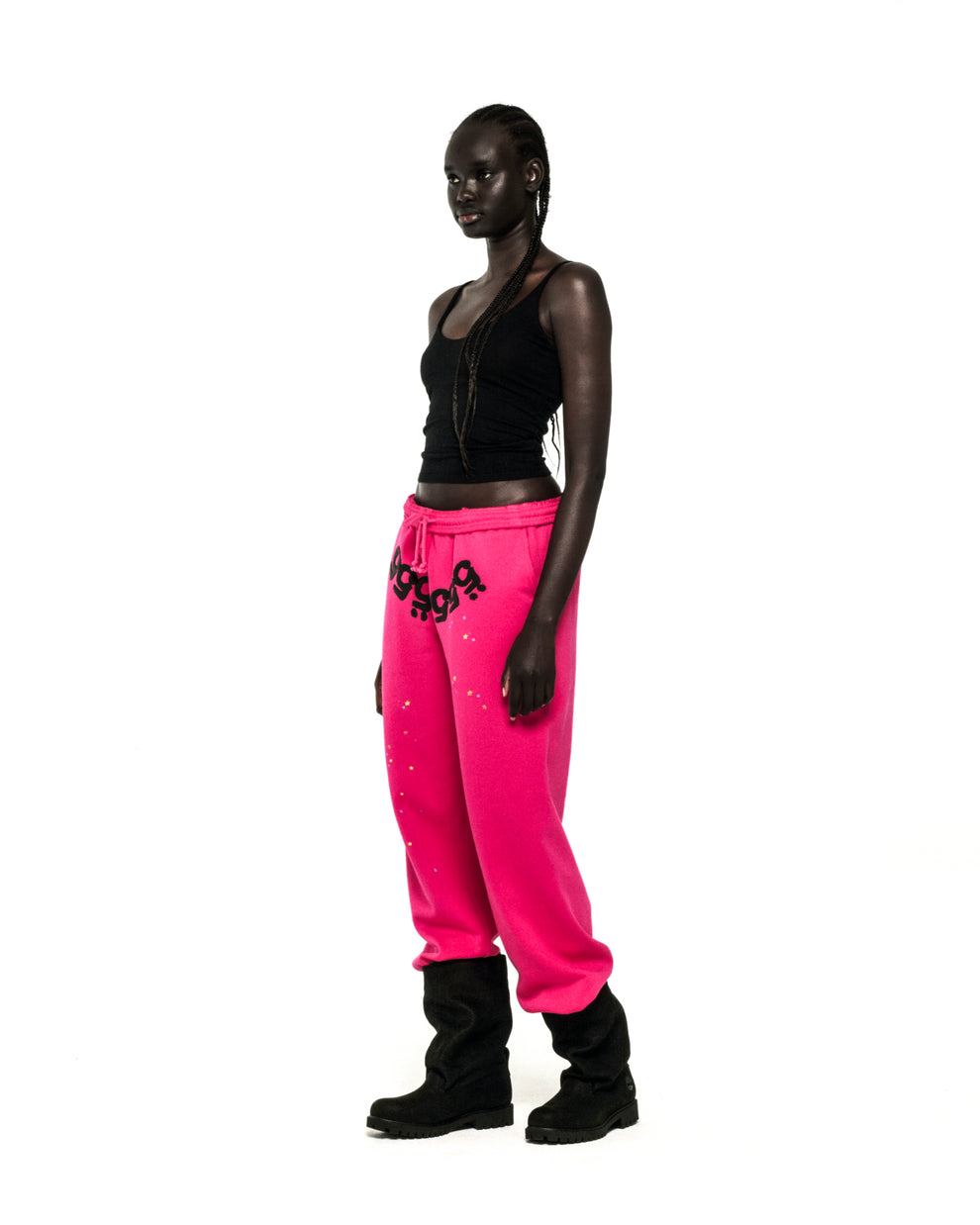 Model wears hot pink ANGEL NUMBER SWEATPANTS with '555' puff print and star details.