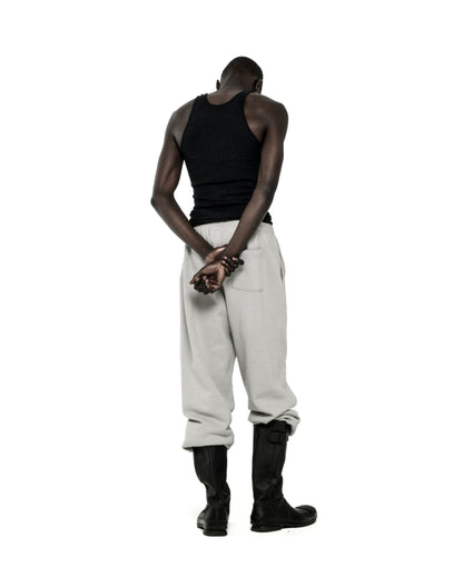 Man in light grey TONAL PUNK V2 SWEATPANTS with elasticized cuffs and waistband.