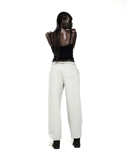 Light grey cotton fleece sweatpants with elasticized waistband and cuffs, seen from behind.