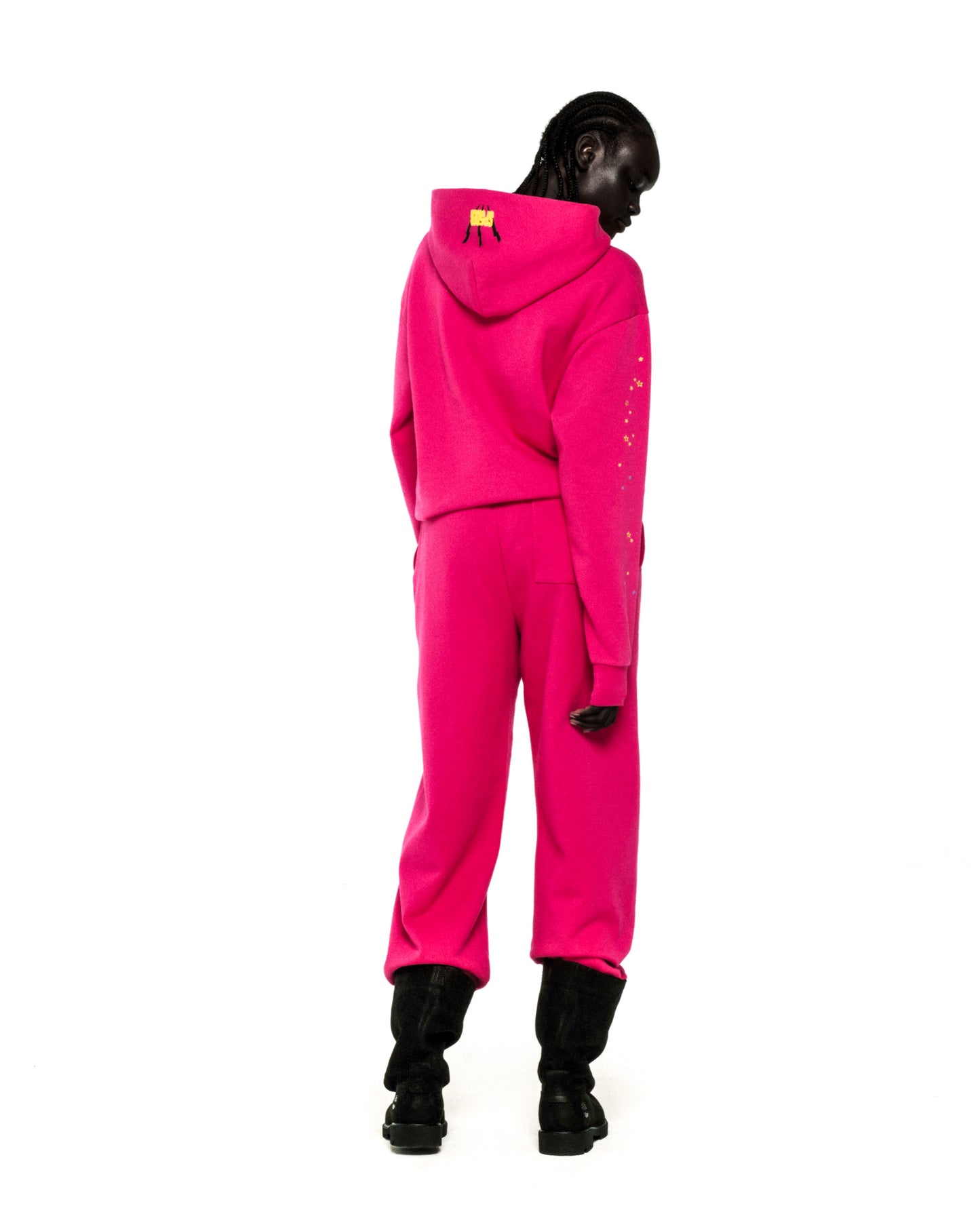 Hot pink 13oz cotton fleece hoodie and sweatpants set with yellow SP5DER logo and star prints.