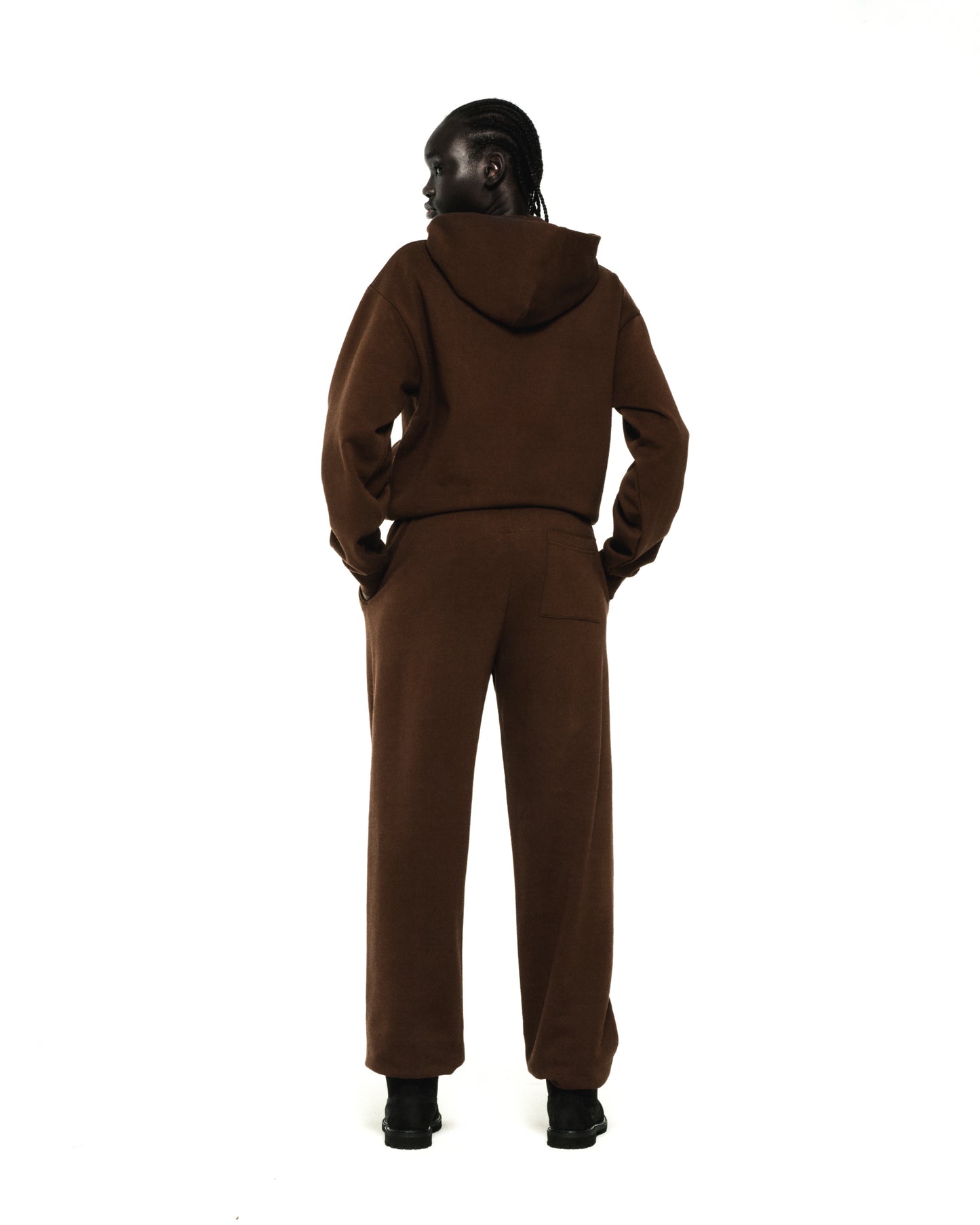 Model wearing a brown RHINESTONE OG WEB HOODIE and matching sweatpants, seen from the back.