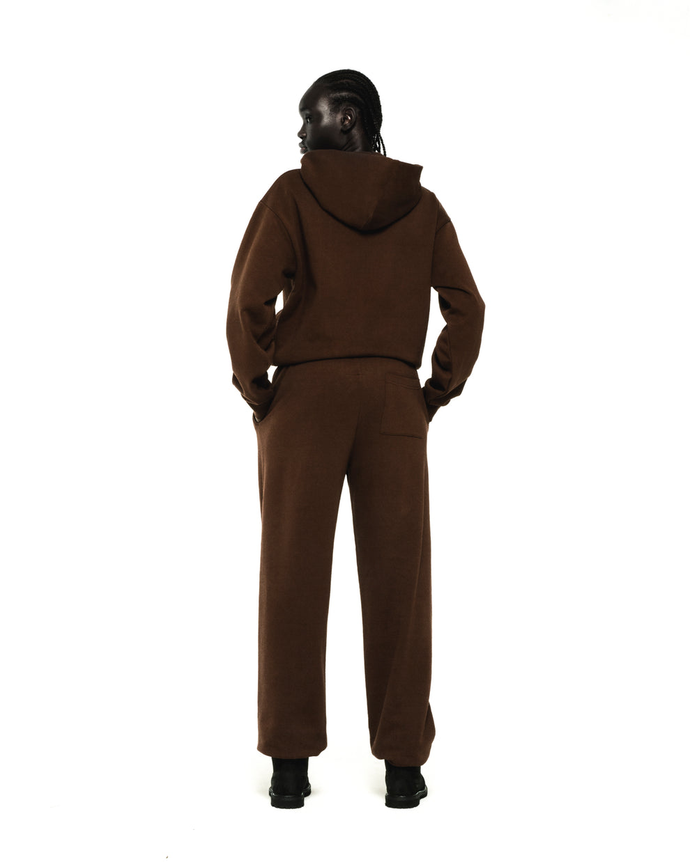 Model wearing a brown RHINESTONE OG WEB HOODIE and matching sweatpants, seen from the back.