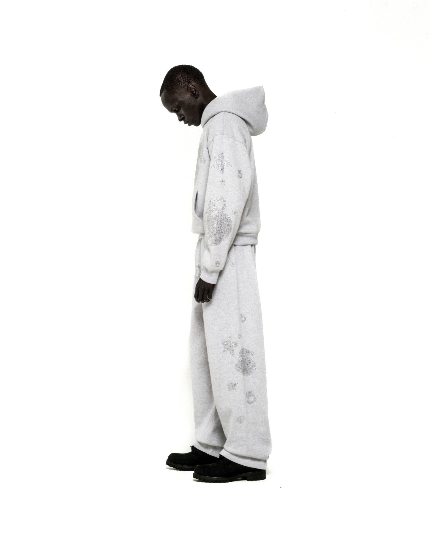 Light grey rhinestone-embellished cotton fleece hoodie and sweatpants set with 'SP5DER' and star designs.