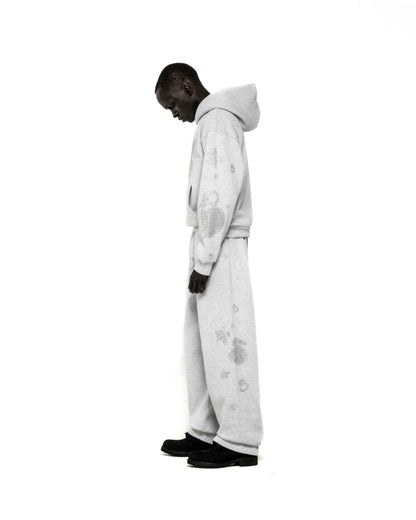 Light grey rhinestone-embellished cotton fleece hoodie and sweatpants set with 'SP5DER' and star designs.