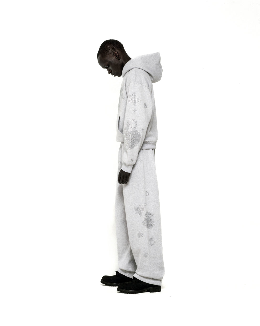 Light grey rhinestone-embellished cotton fleece hoodie and sweatpants set with 'SP5DER' and star designs.