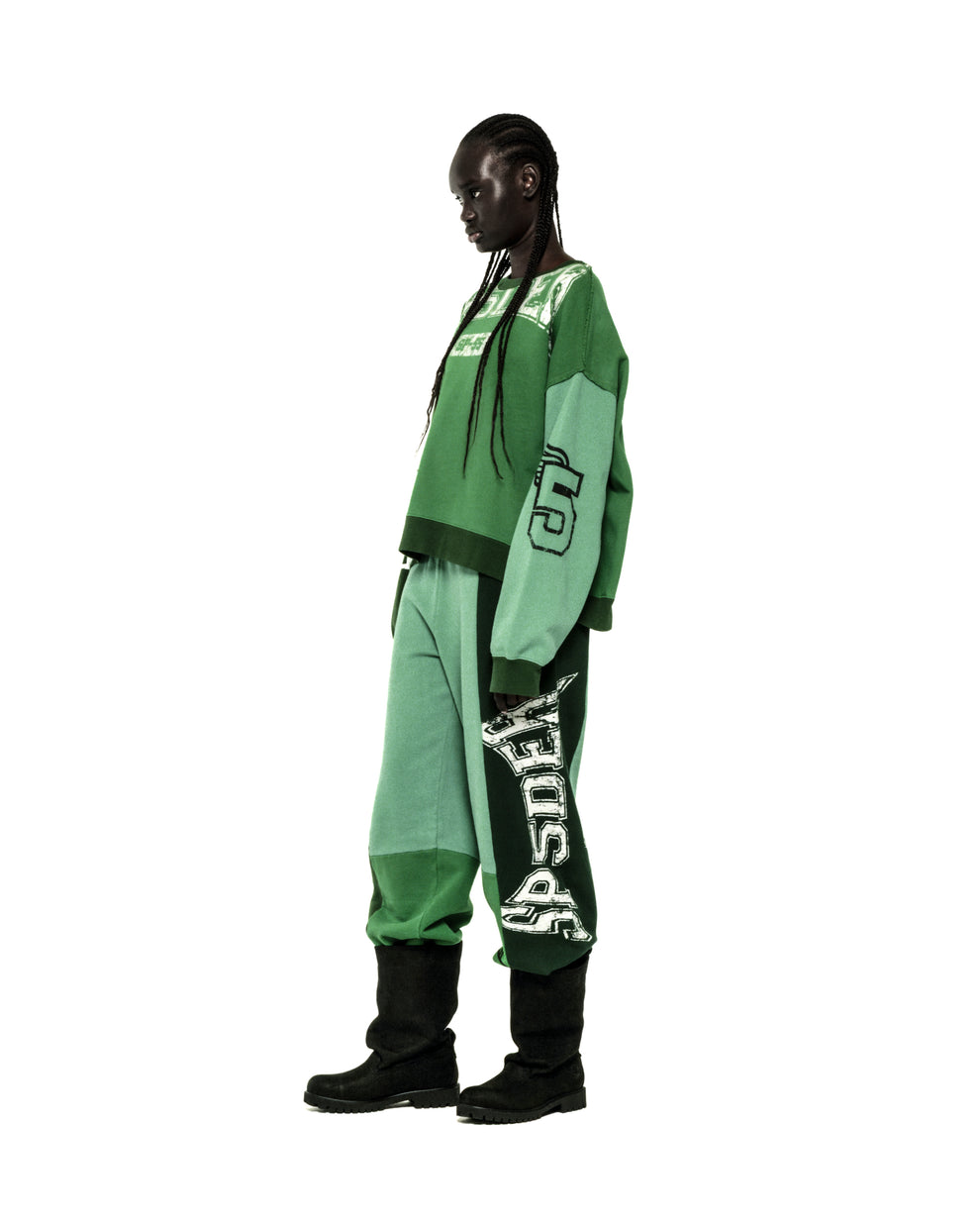 Model in SUPERFIVE CREWNECK and sweatpants. Green color block, graphic print, 100% cotton brushed fleece.