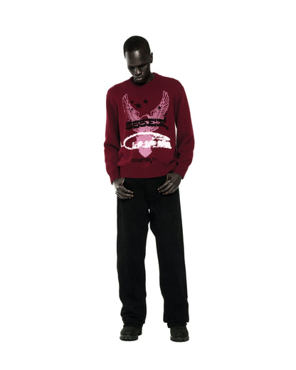 Red knit sweater with graphic print, ribbed collar, hem, and cuffs, worn by a man.