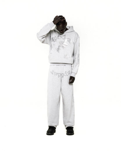 Light grey rhinestone embellished 'SP5DER' hoodie and sweatpants set on a model.