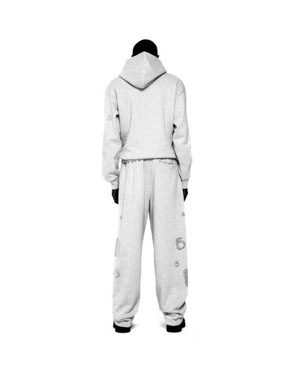 Light grey rhinestone embellished hoodie and sweatpants set with 'SP5DER' and star design.
