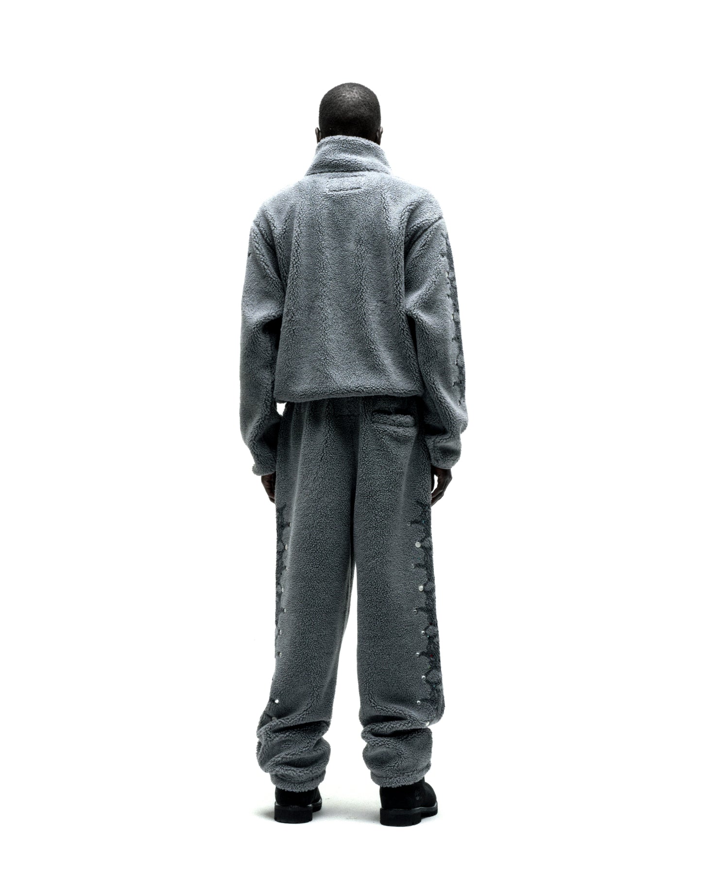 Gray sherpa fleece zip-up jacket and matching pants with web print and rhinestone sleeves.