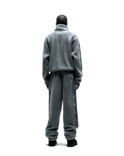 Gray sherpa fleece zip-up jacket and matching pants with web print and rhinestone sleeves.