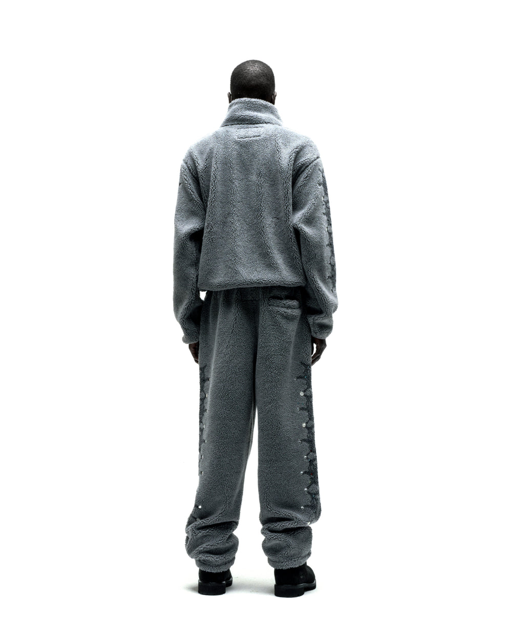 Gray sherpa fleece zip-up jacket and matching pants with web print and rhinestone sleeves.