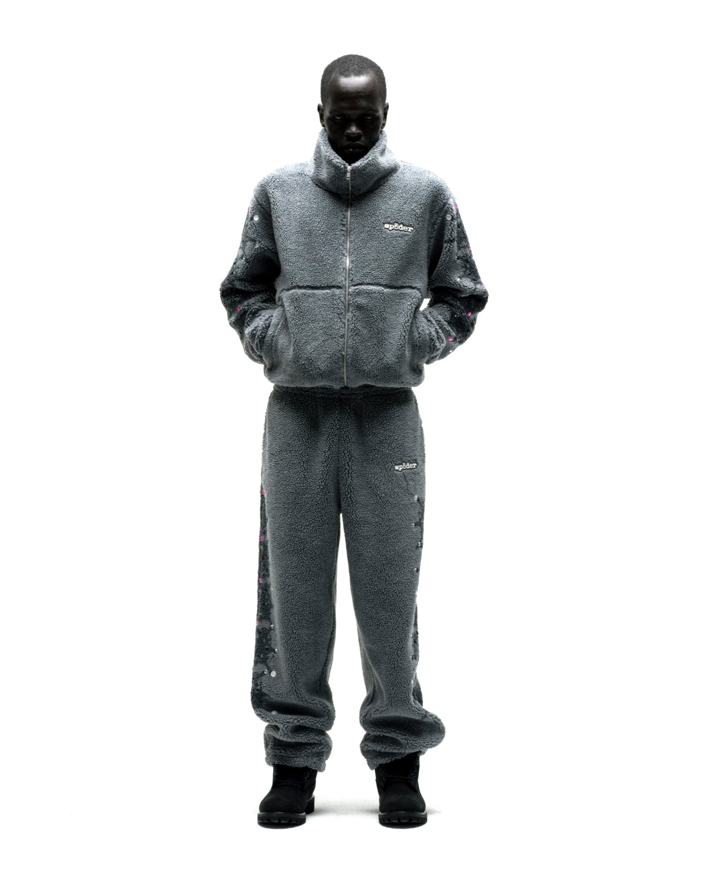 Gray sherpa fleece zip-up jacket and pants with web print, rhinestones, and logo patch.