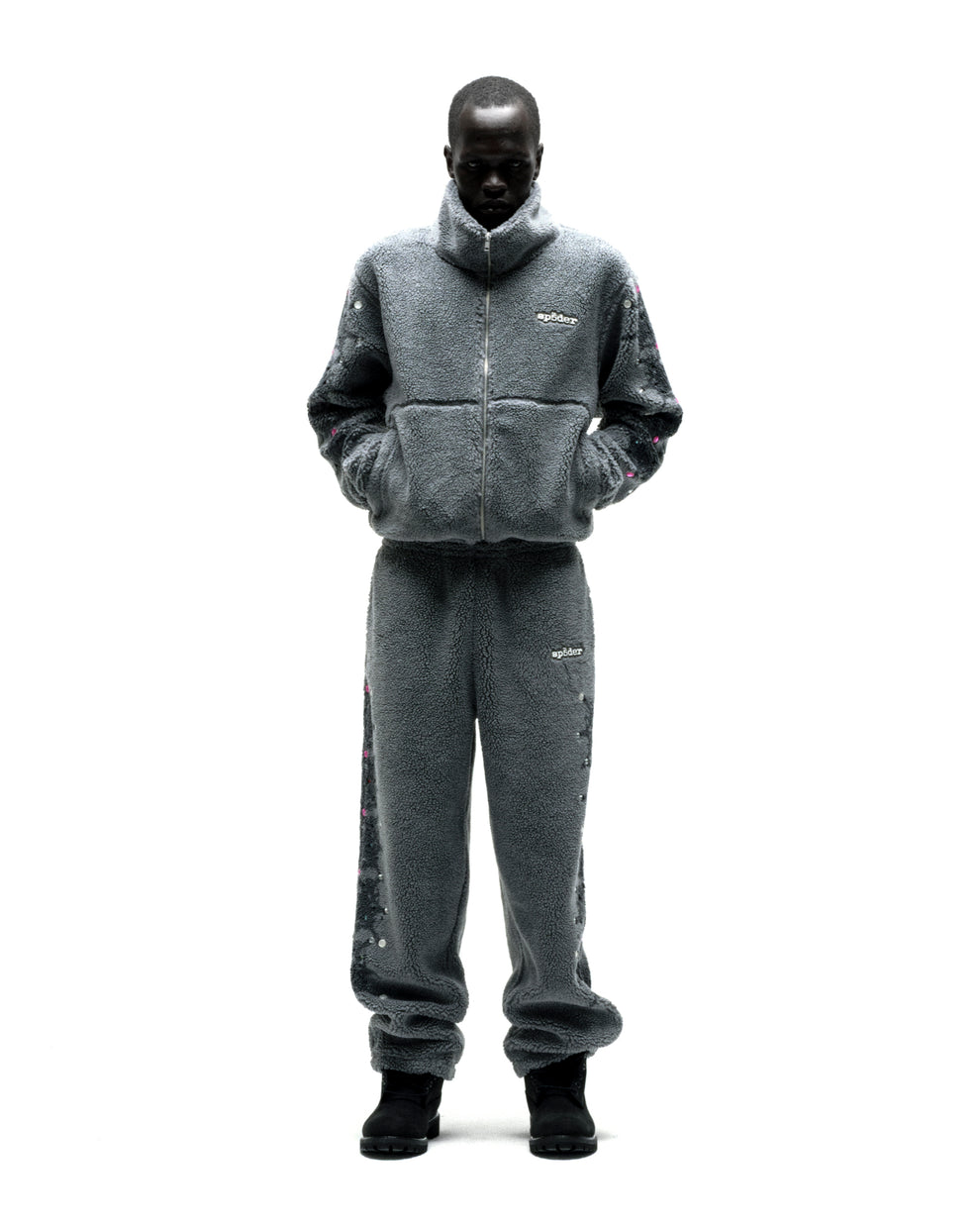 Gray sherpa fleece zip-up jacket and pants with web print, rhinestones, and logo patch.