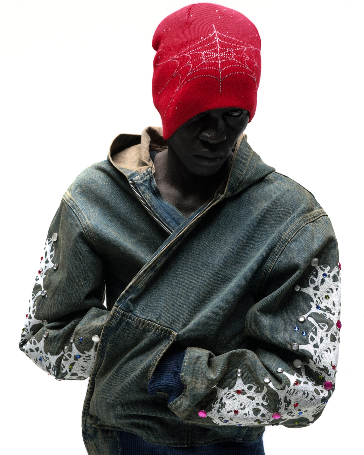 Red acrylic rhinestone silk skully with spiderweb design, worn by a model.