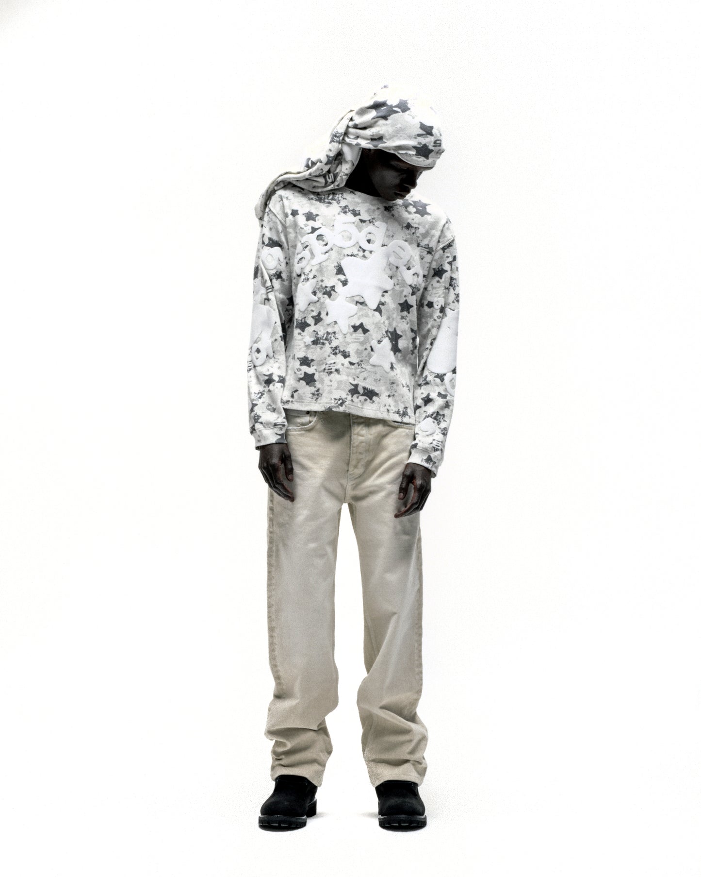 BELUGA AOP thermal, waffle knit, star camo print, ribbed collar/hem/cuffs, worn with beige pants.