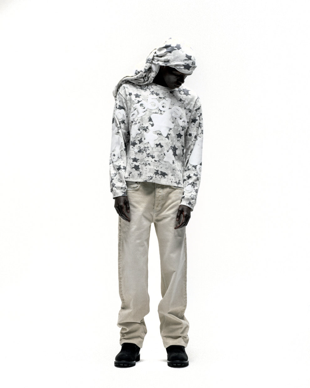 BELUGA AOP thermal, waffle knit, star camo print, ribbed collar/hem/cuffs, worn with beige pants.