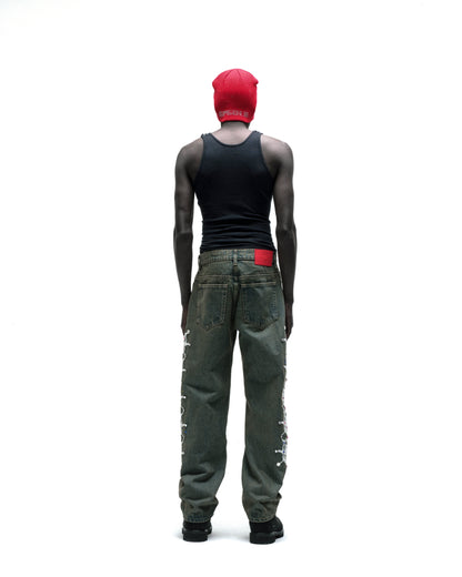 Red rhinestone embellished acrylic skully, black tank top, and distressed jeans with white side lacing.