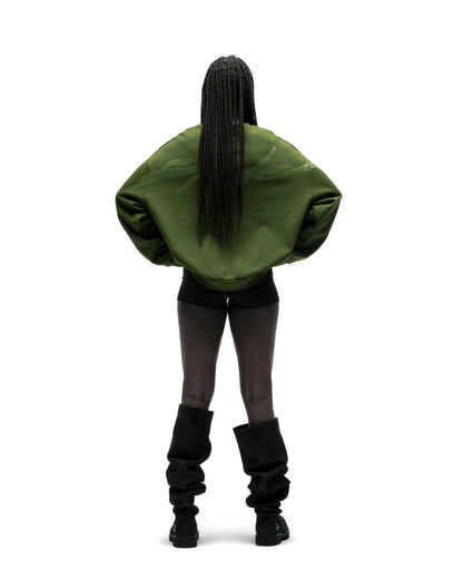 Back view of a person wearing an oversized olive green RHINESTONE TM CREWNECK with embellished graphic.