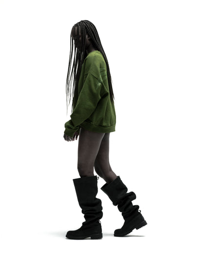 Green 100% cotton RHINESTONE TM CREWNECK with rhinestone graphic, worn by a model with black boots.