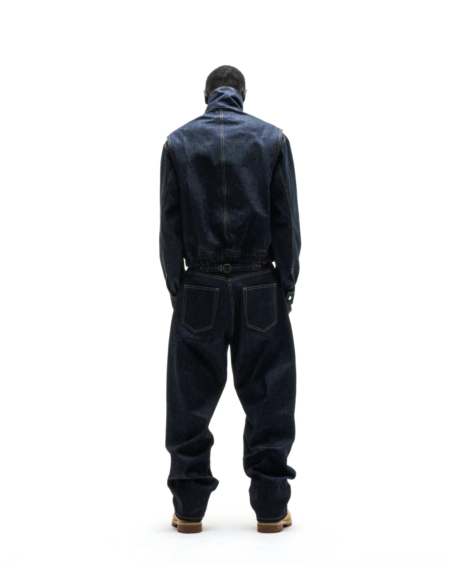 Dark wash denim jacket and pants with yellow stitching, custom script logo, and silver hardware.