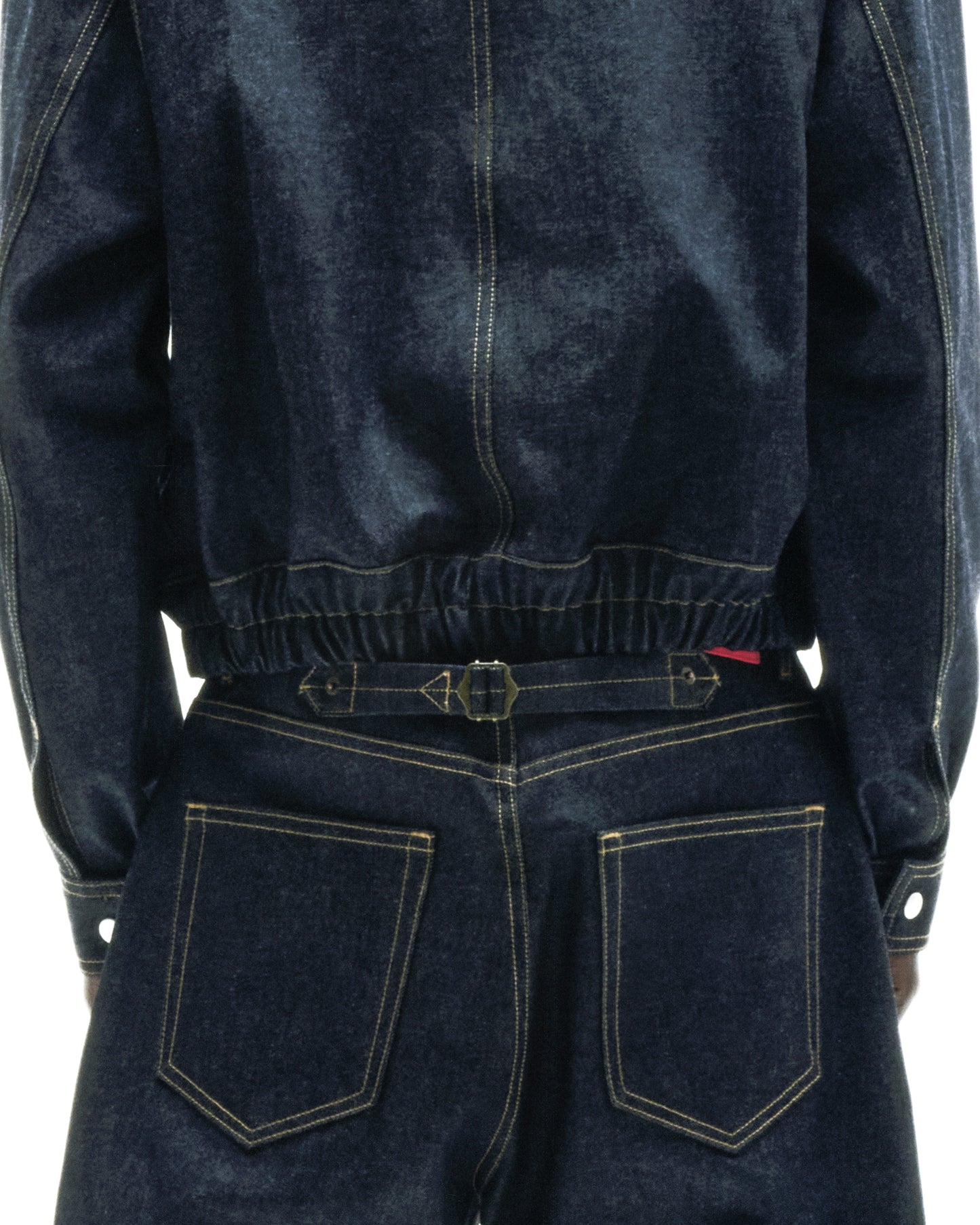 Dark wash denim jacket and jeans with gold stitching, featuring an adjustable buckle-back cinch on the jeans.