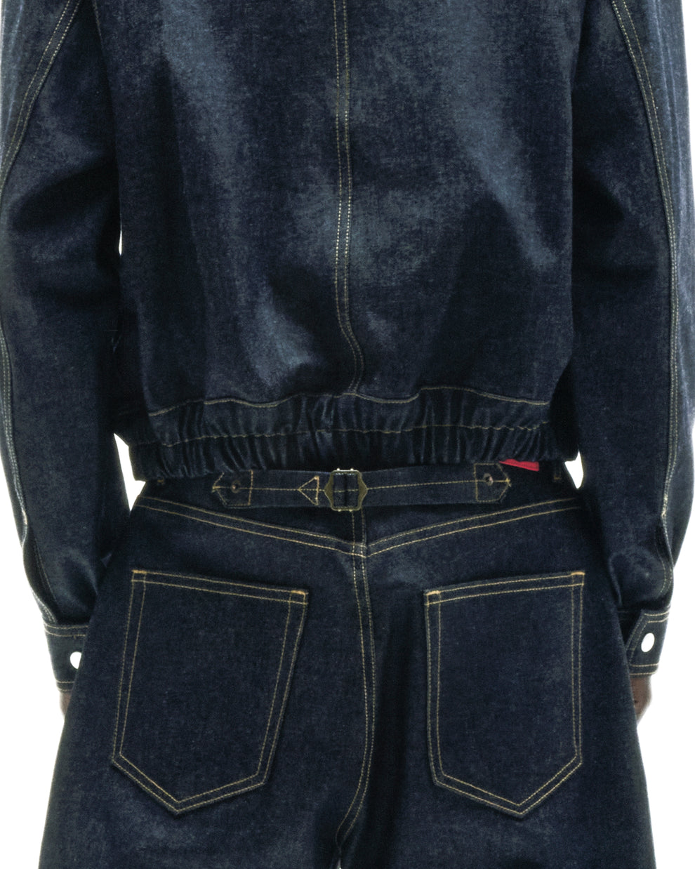 Dark wash denim jacket and jeans with gold stitching, featuring an adjustable buckle-back cinch on the jeans.