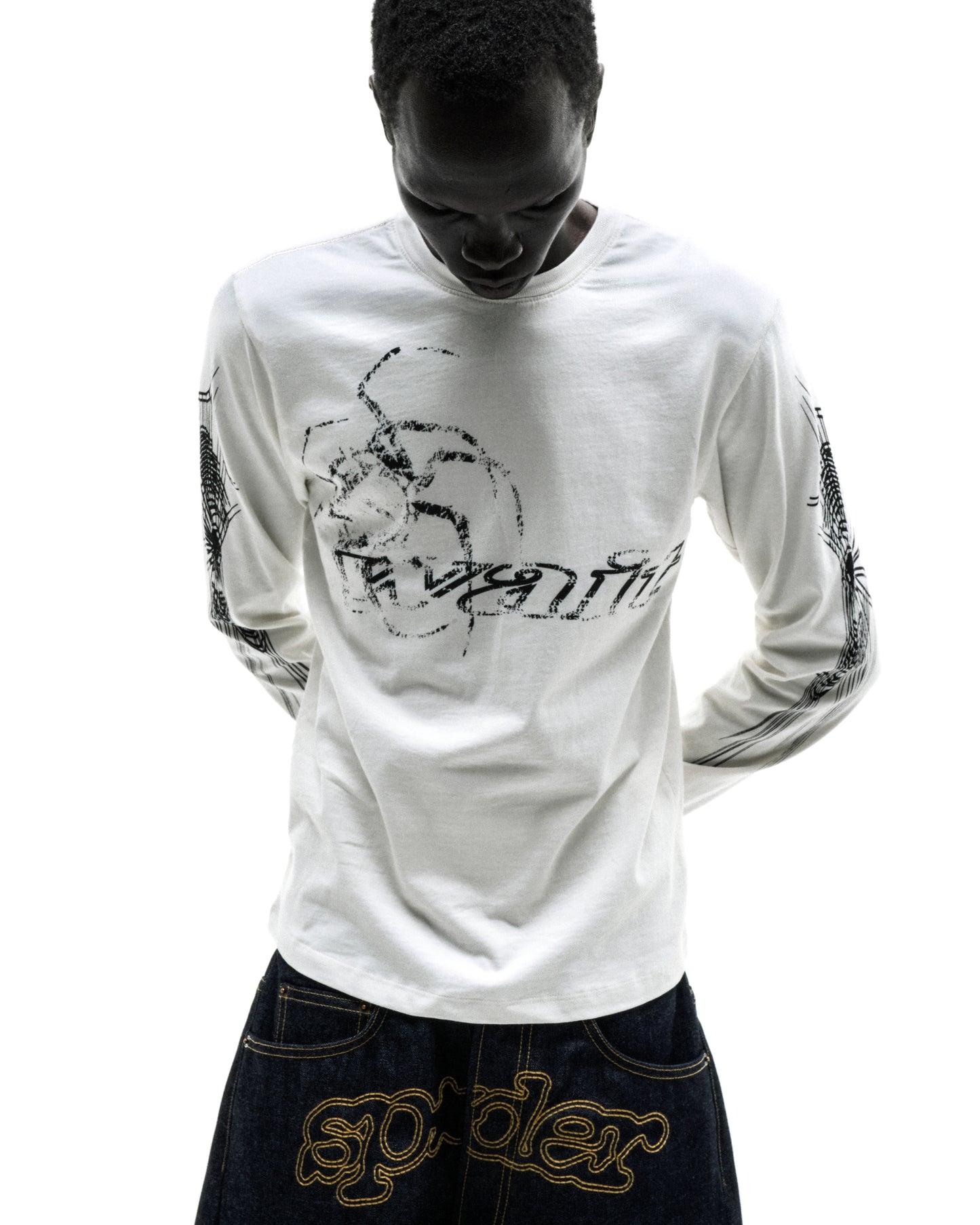 White 100% cotton long sleeve tee with black graphic print on sleeves and chest, ribbed collar and cuffs.