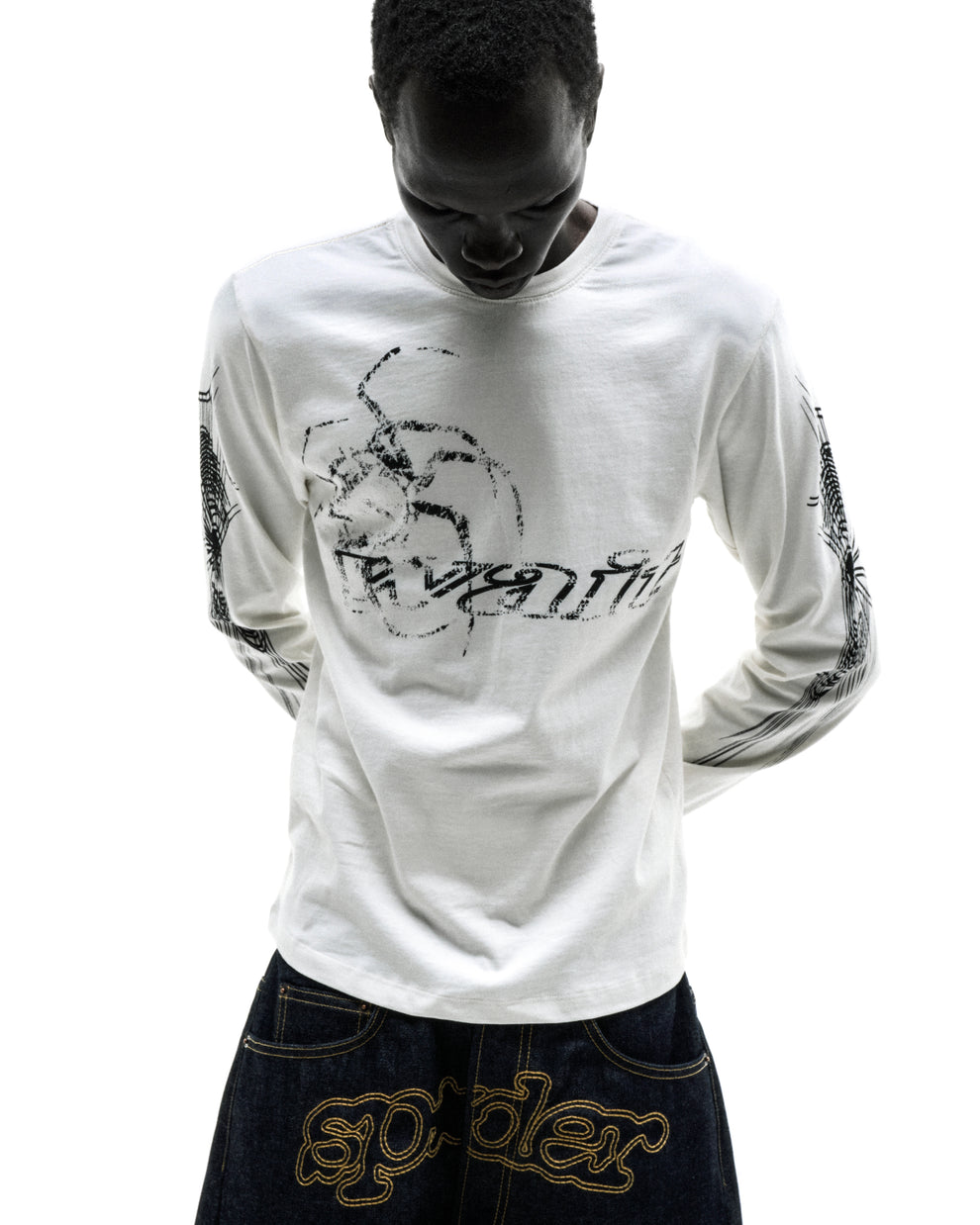 White 100% cotton long sleeve tee with black graphic print on sleeves and chest, ribbed collar and cuffs.
