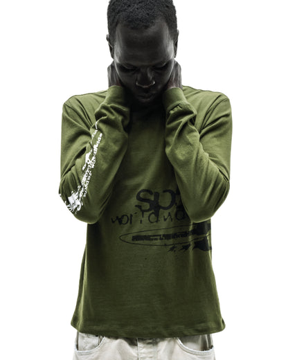 Man in olive green cotton long sleeve tee with black and white graphic prints, ribbed collar and cuffs.