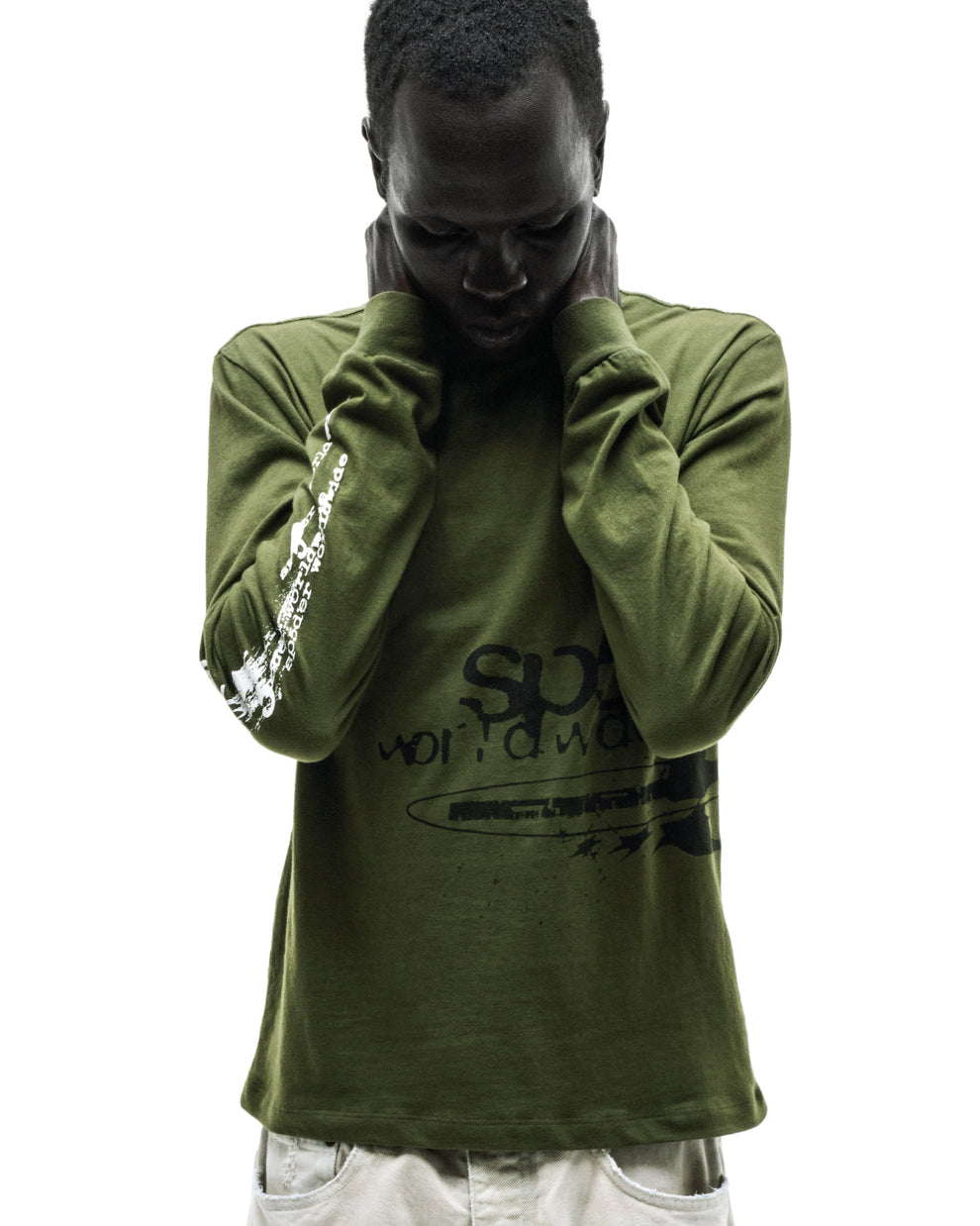 Man in olive green cotton long sleeve tee with black and white graphic prints, ribbed collar and cuffs.