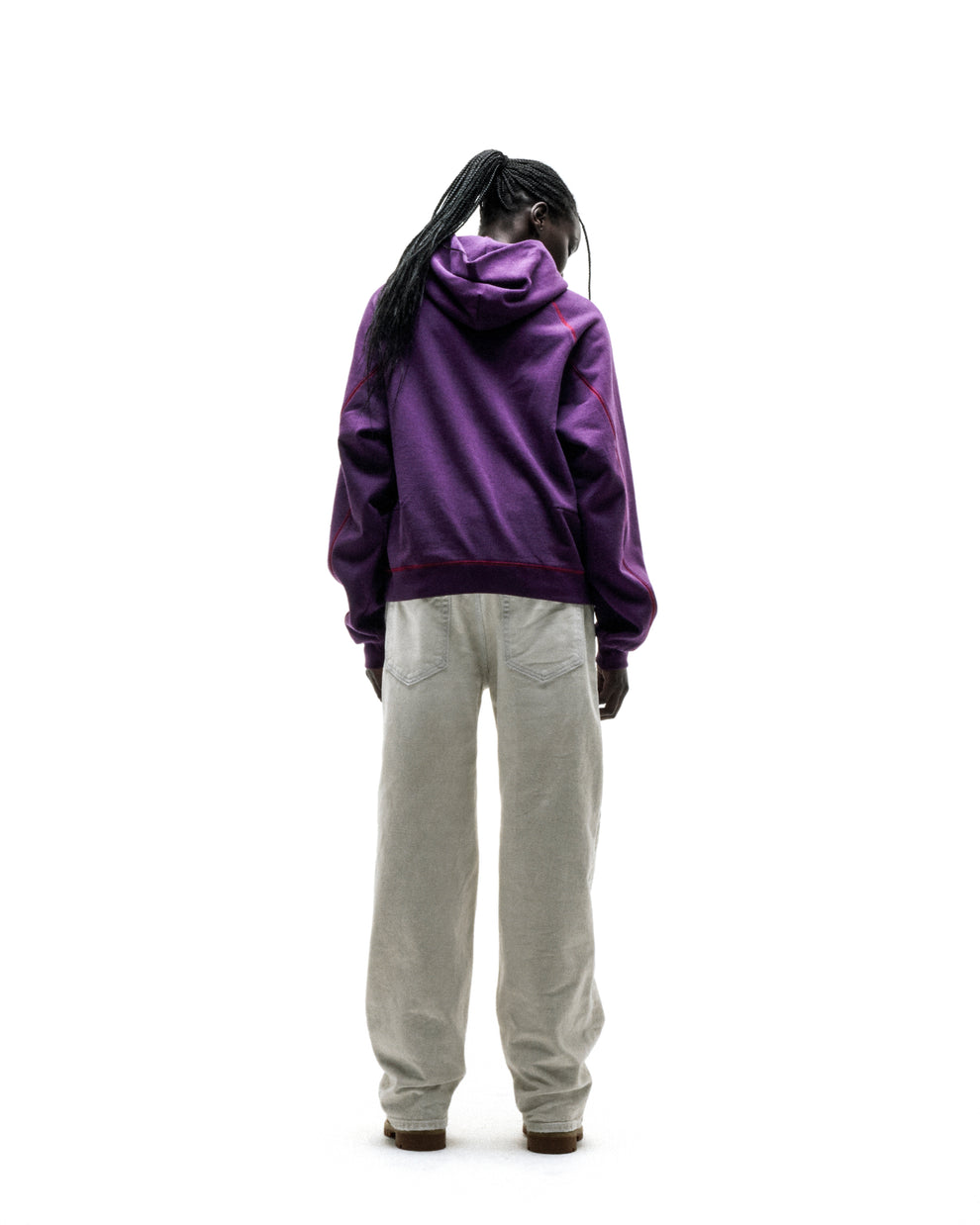 Purple SPLAT COLLISION HOODIE with contrast red stitching, rib knit hem/cuffs, and kangaroo pocket, worn by a person facing away.
