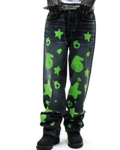 Faded wash BELUGA STAMP DENIM jeans with bright green star and number 6 designs.