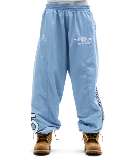 Light blue nylon SCRIPT WARM UP PANT with white embroidered graphics, elasticized waist, and cuffs.