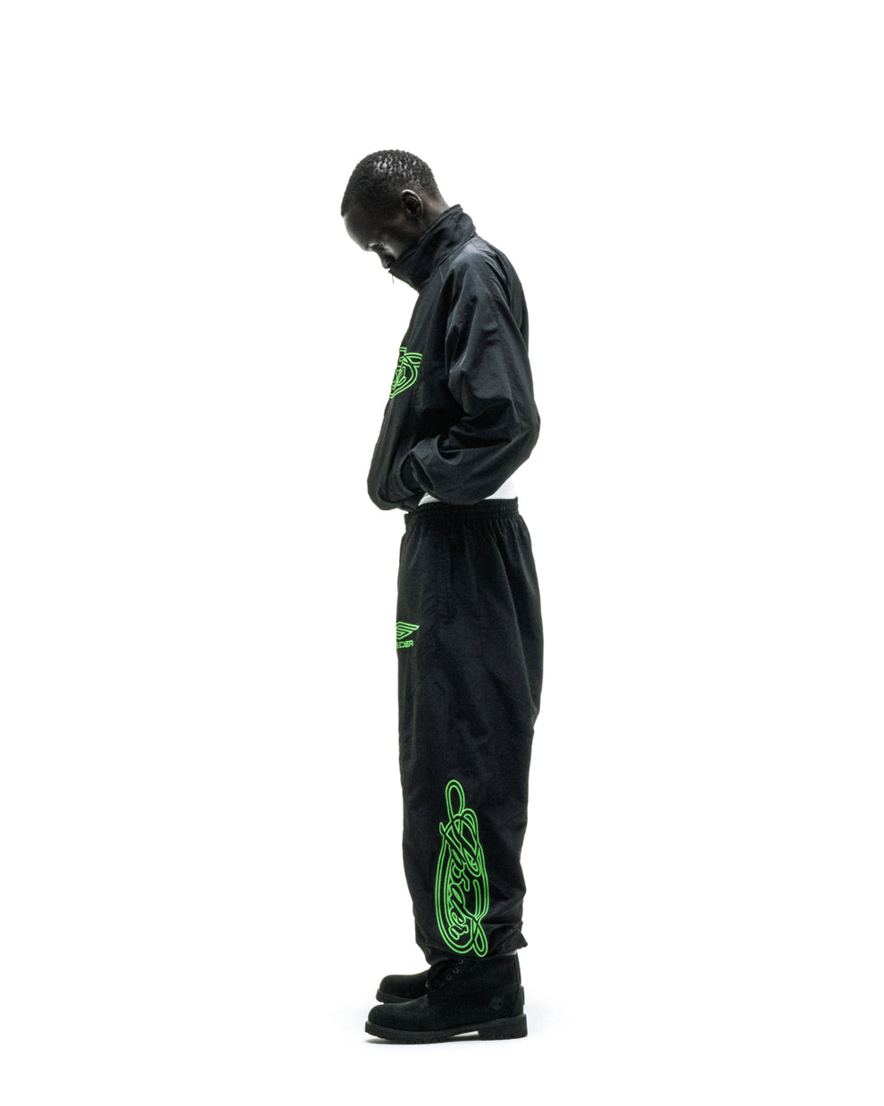 Black nylon track jacket and pants with neon green embroidered logos and sleeve graphic.
