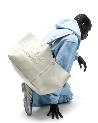 GHOST LEATHER TOTE BAG: Cream genuine leather tote with embossed logo and "EST. 2019" detail.